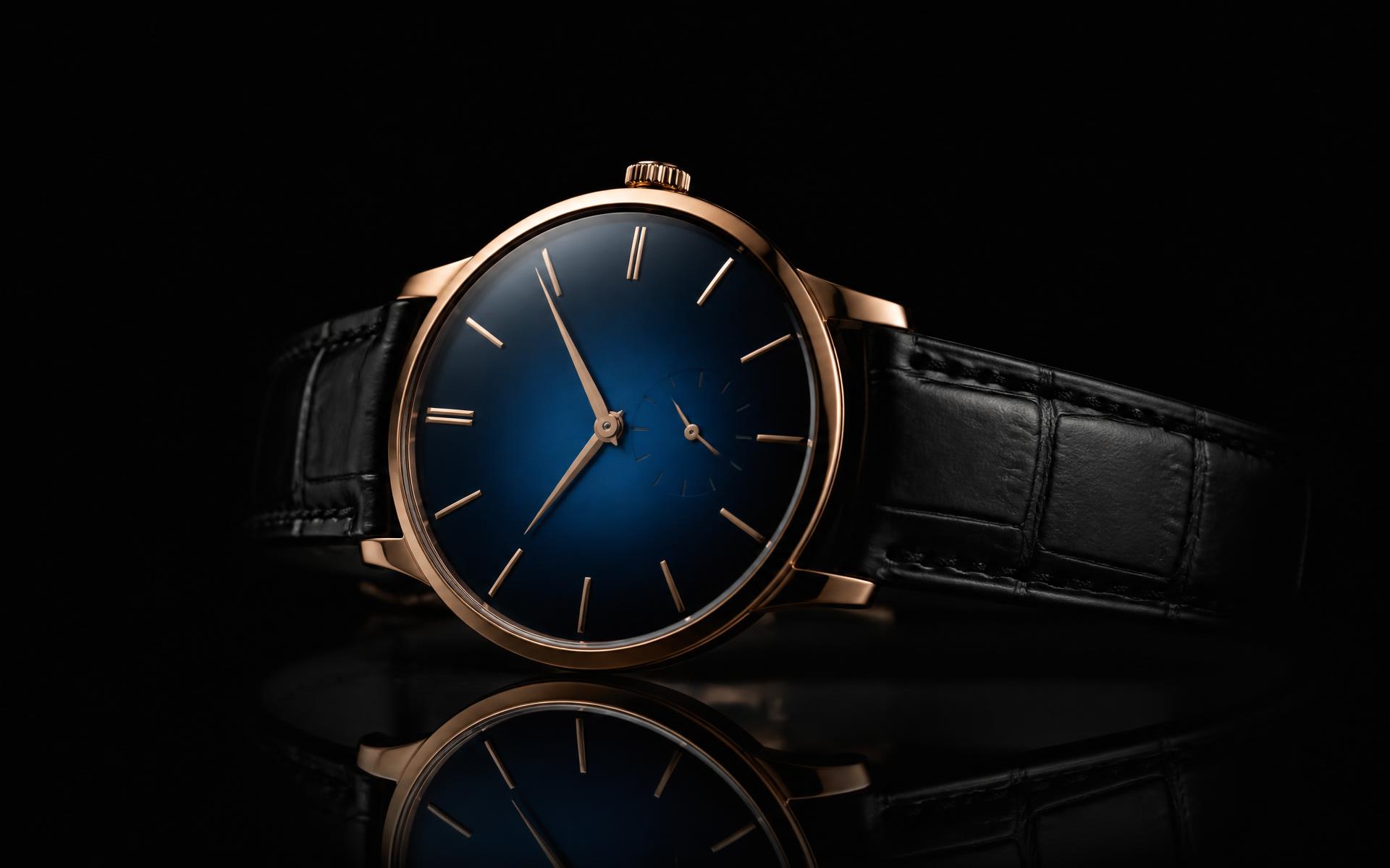 Rose gold dress watch on dark glass